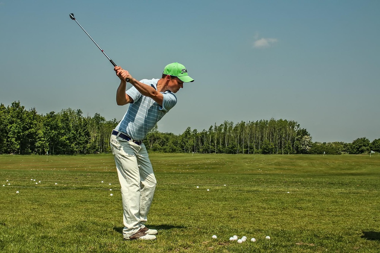 Man practicing golf swing on a driving range